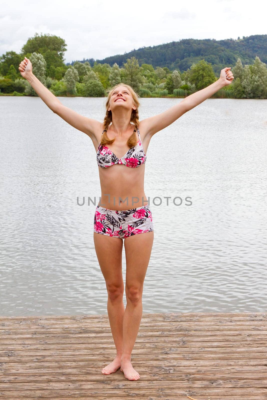 Young,happy woman at the lake