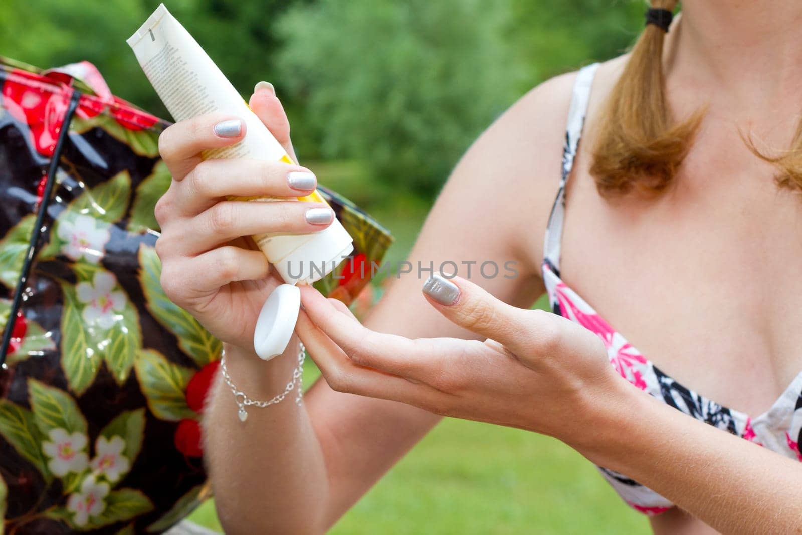 Applying young woman at sunscreen