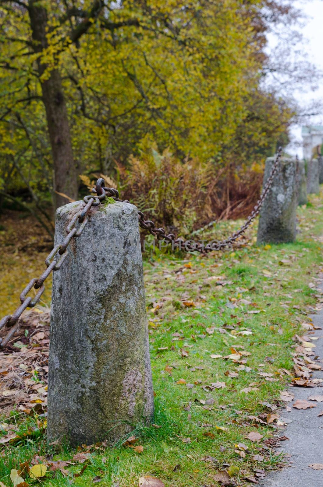 one rusty chain betwen two old stone