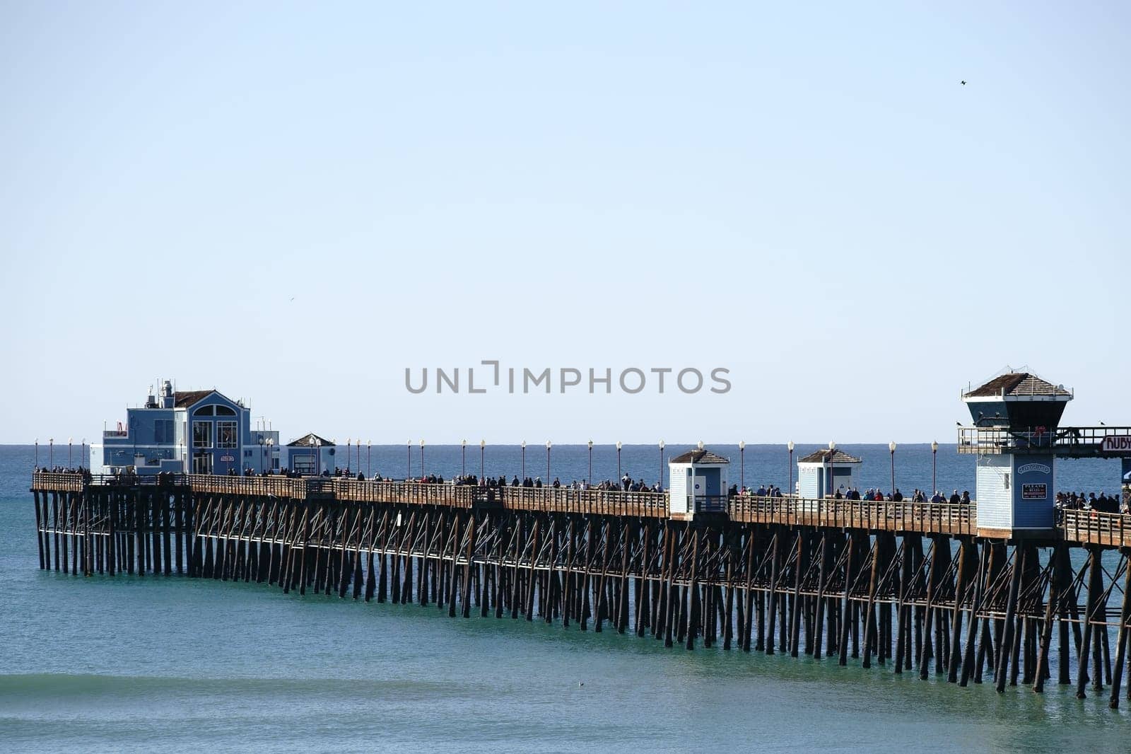 Oceanside,United States - December 25,2015: Visitors and tourists walk over Oceanside Pier in fine weather on December 25,2015 in Oceanside.