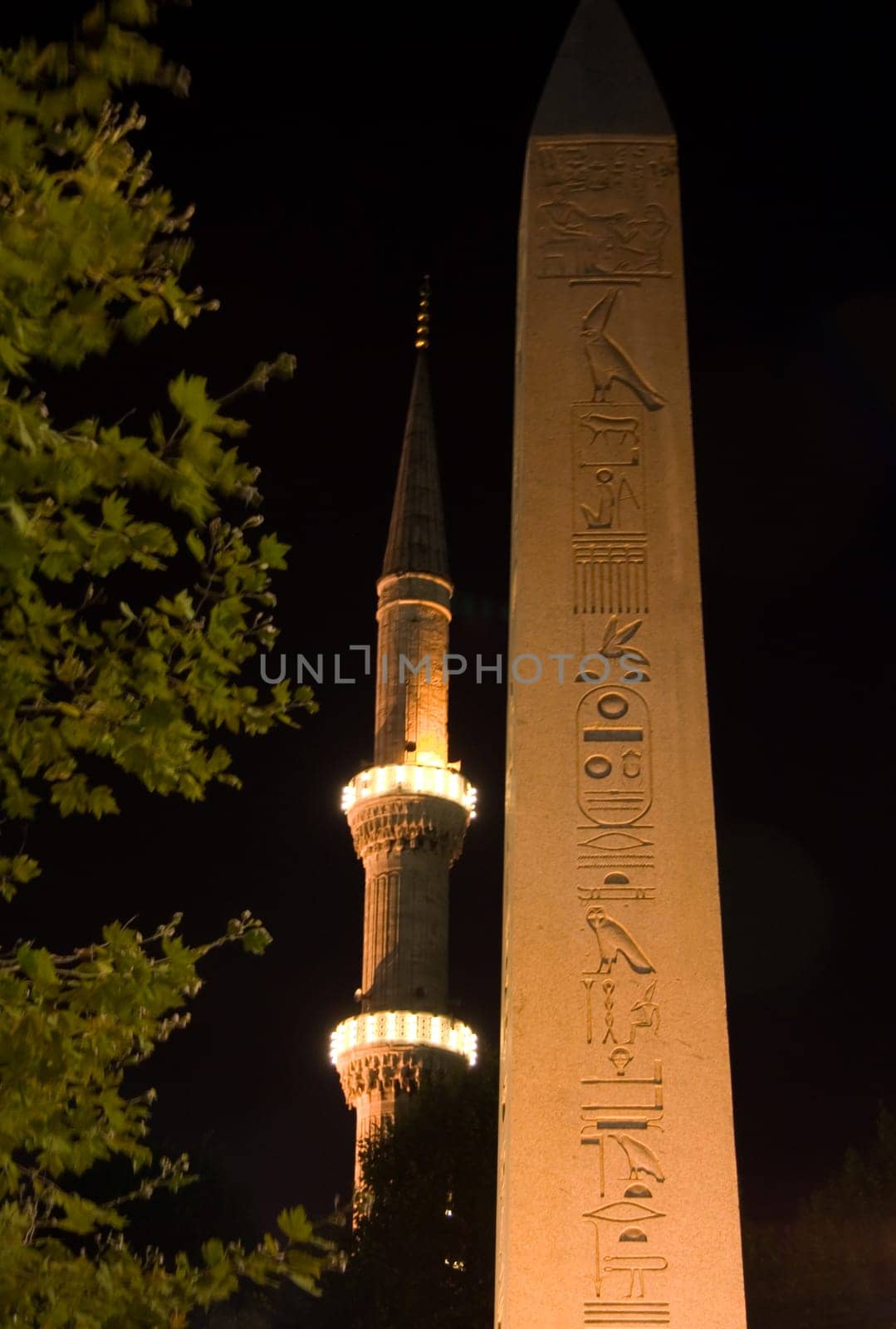 Obelisk and The Blue Mosque Minaret in the background at night, Istanbul