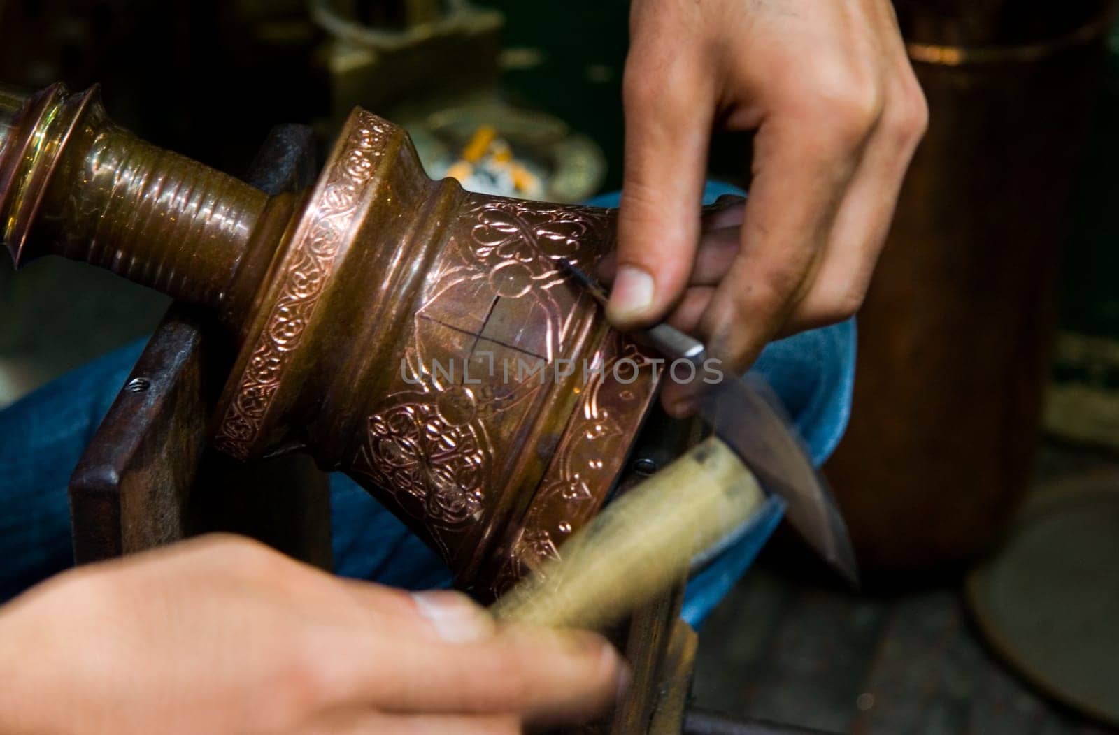 Hands of turkish chaser in process of oriental design calking, Istanbul