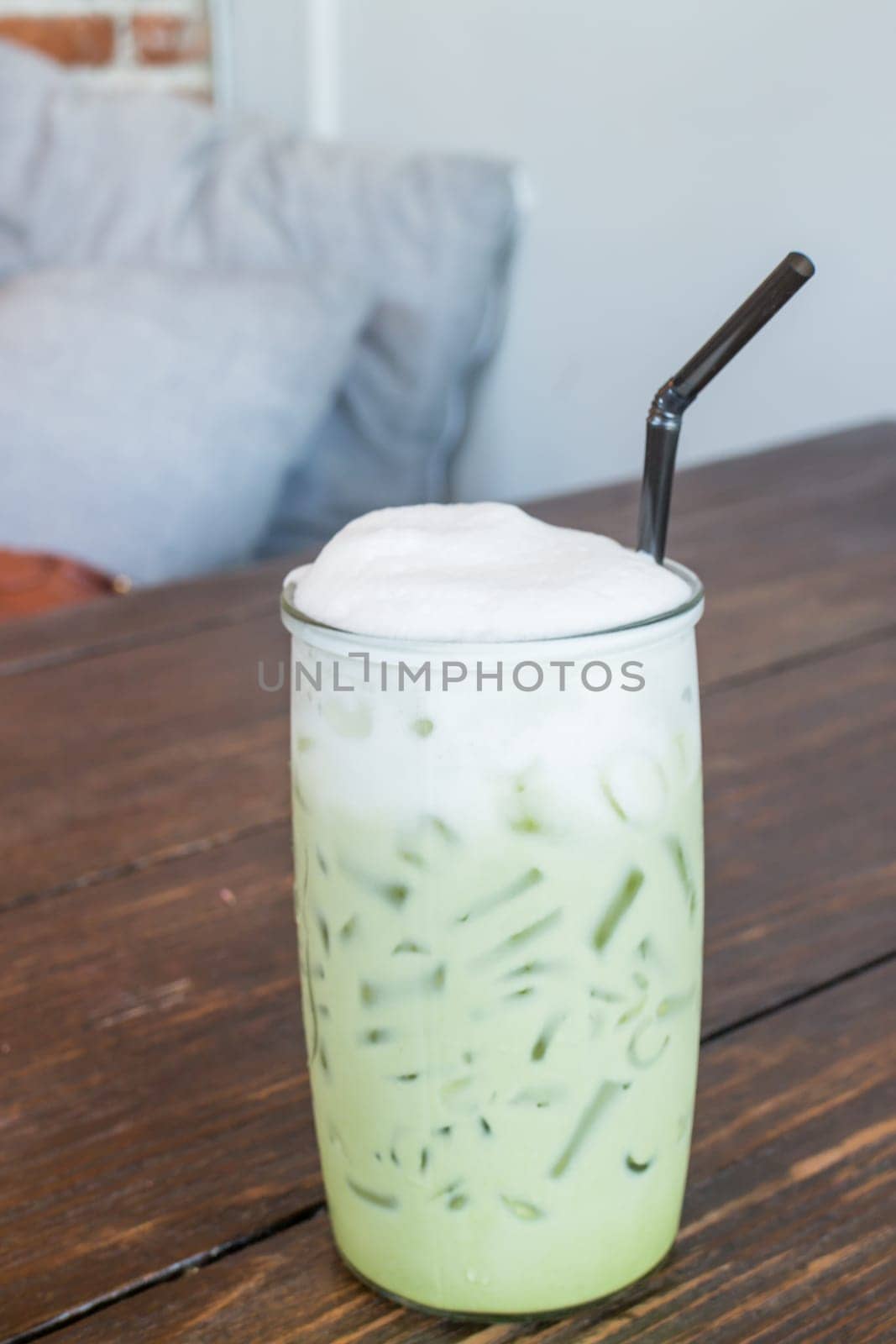 Green tea latte into a cold glass, stock photo
