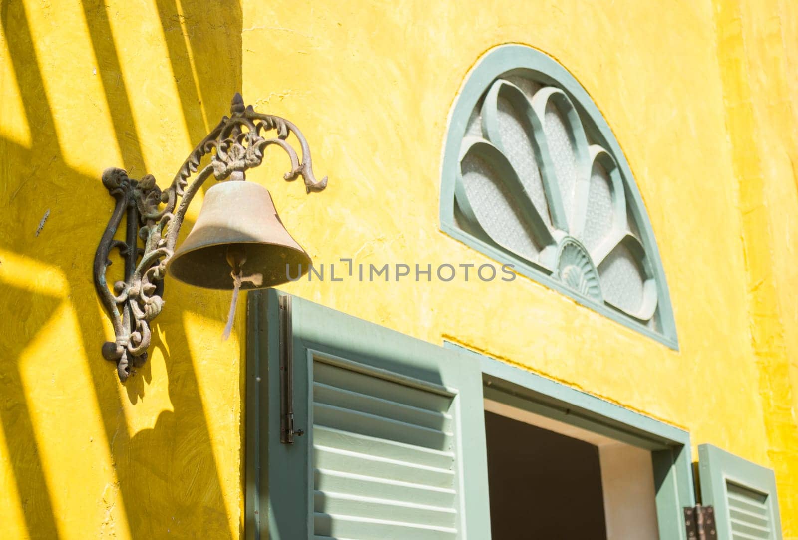Window on yellow cement with shadows, stock photo