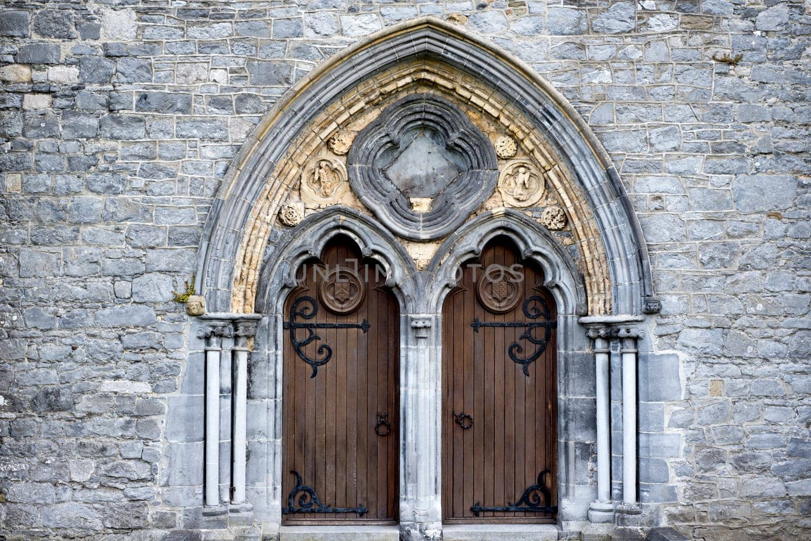 double arched wooden doors in to  St Canice’s Cathedral kilkenny ireland
