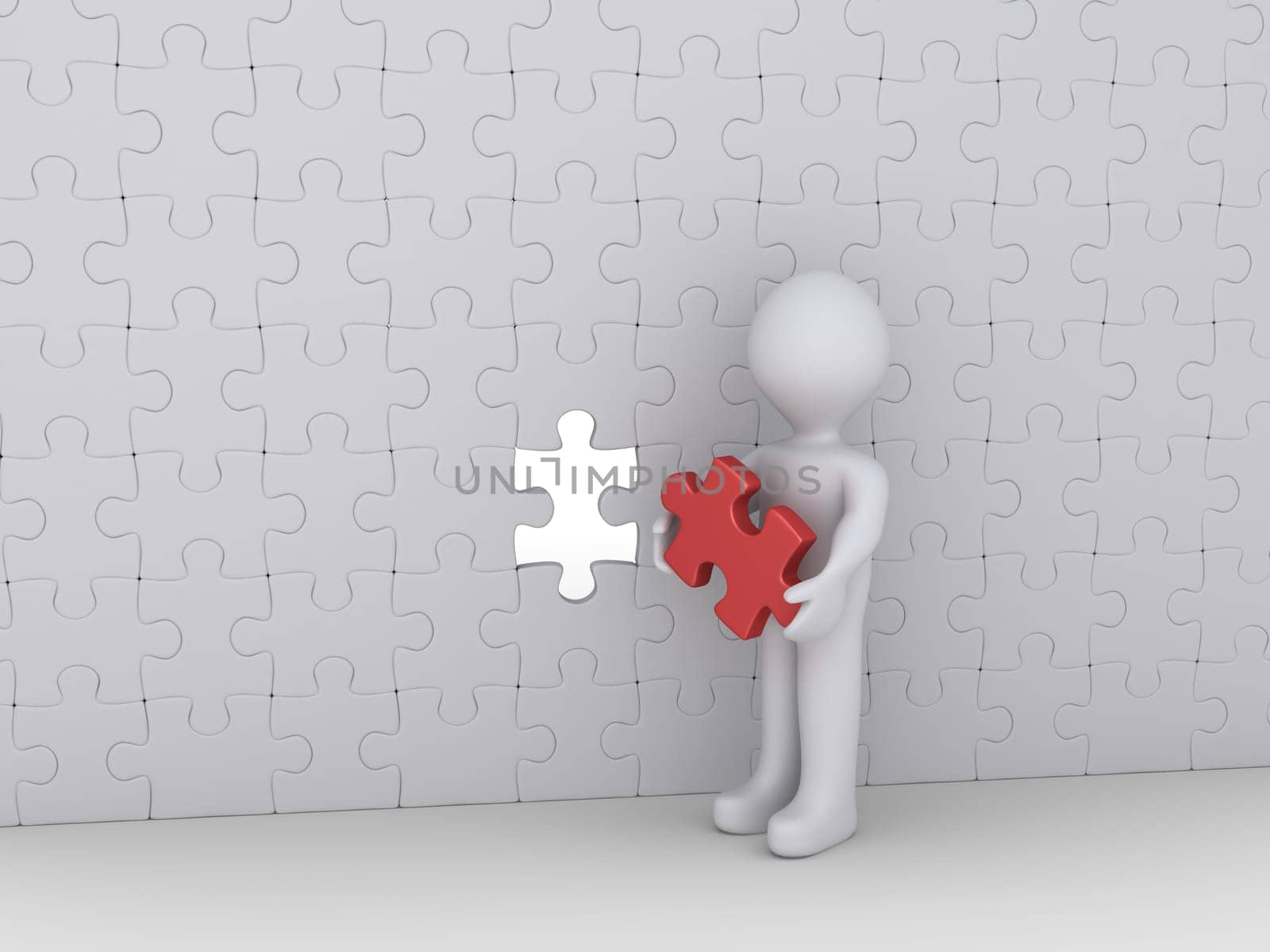 Person is holding the last puzzle piece of a big wall of many pieces