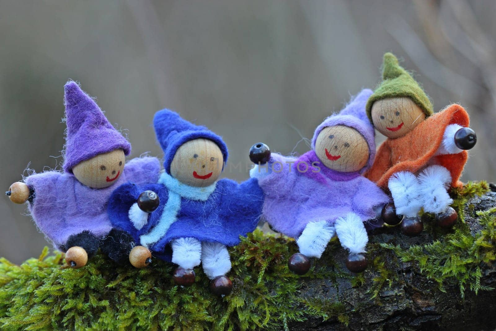 Four little gnomes sit in the moss