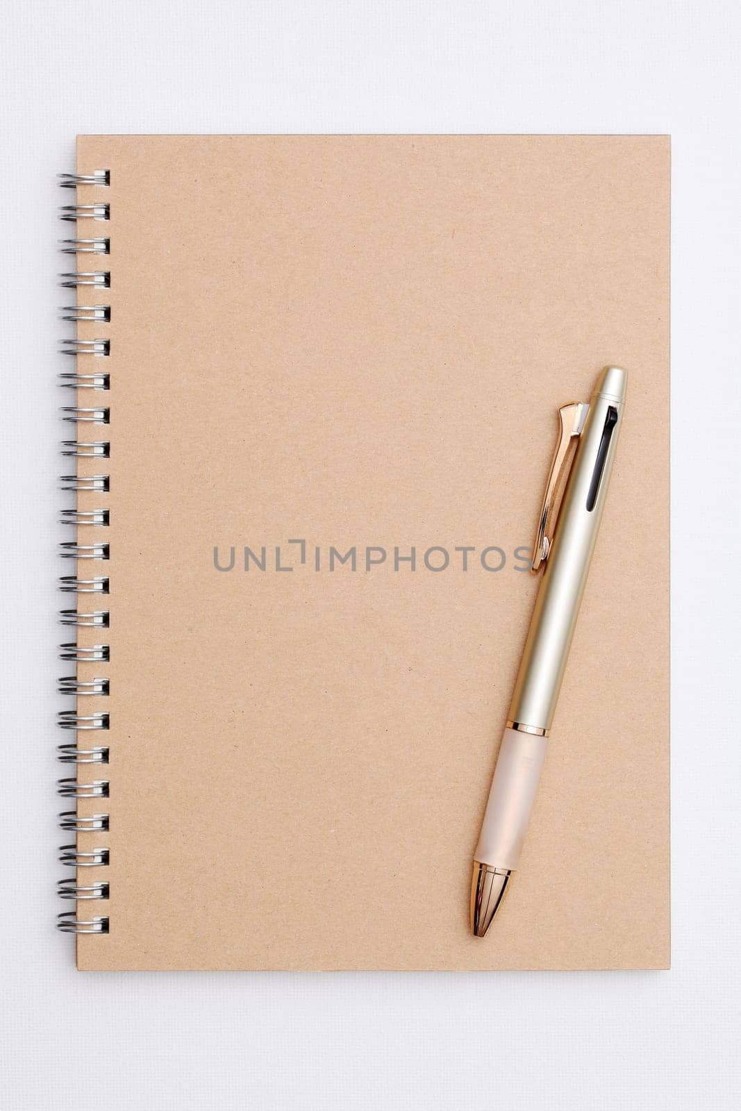 Blank spiral brown notebook with ball point pen