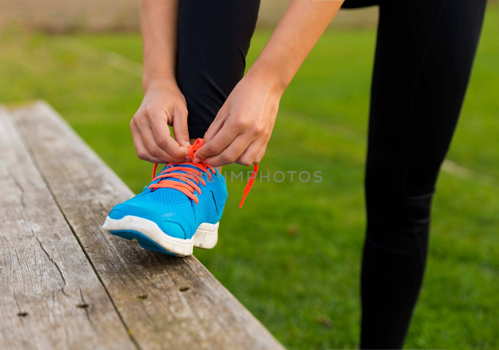 Woman tying her shoes and getting ready for train
