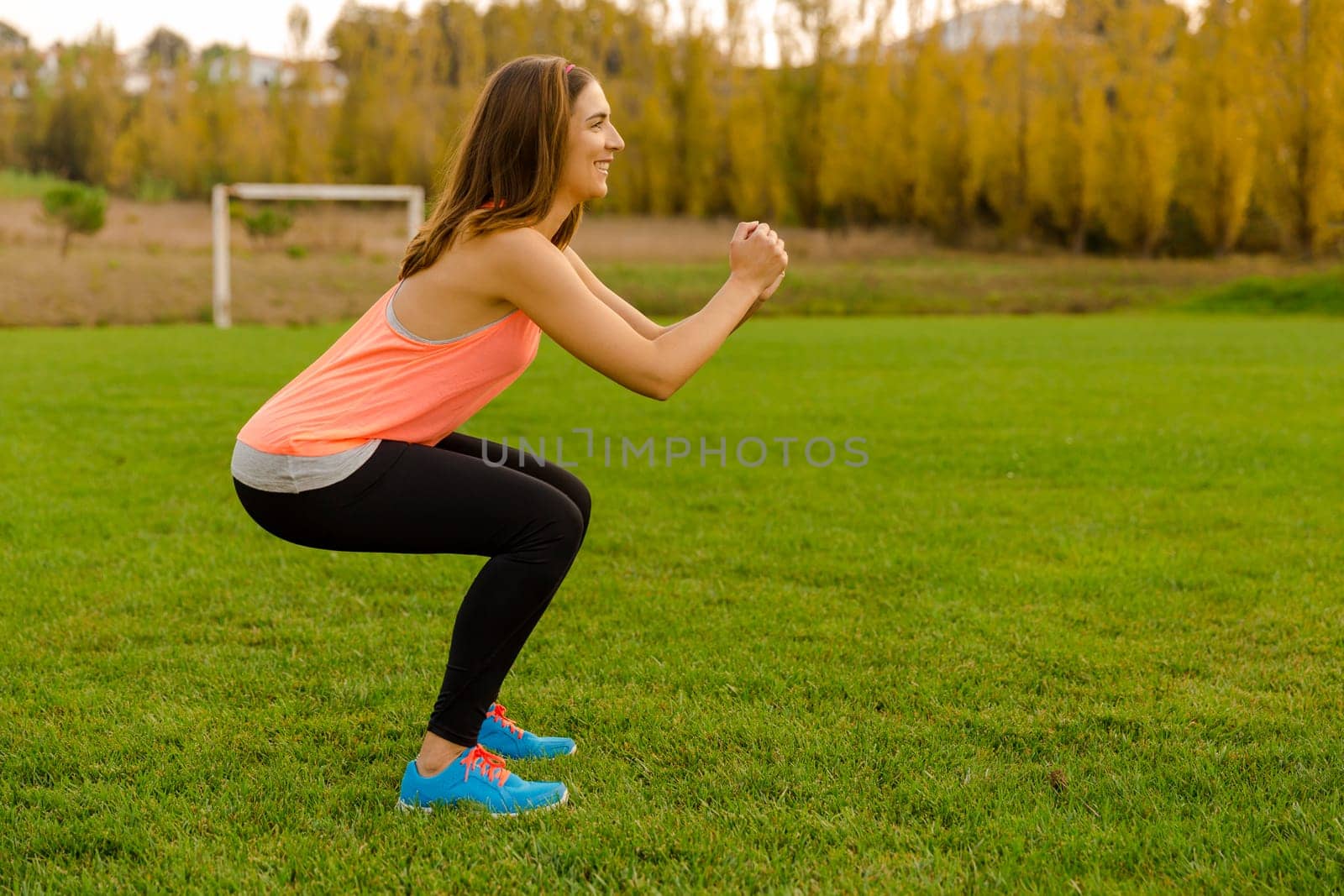 An attractive woman exercising outdoor on a soccer field