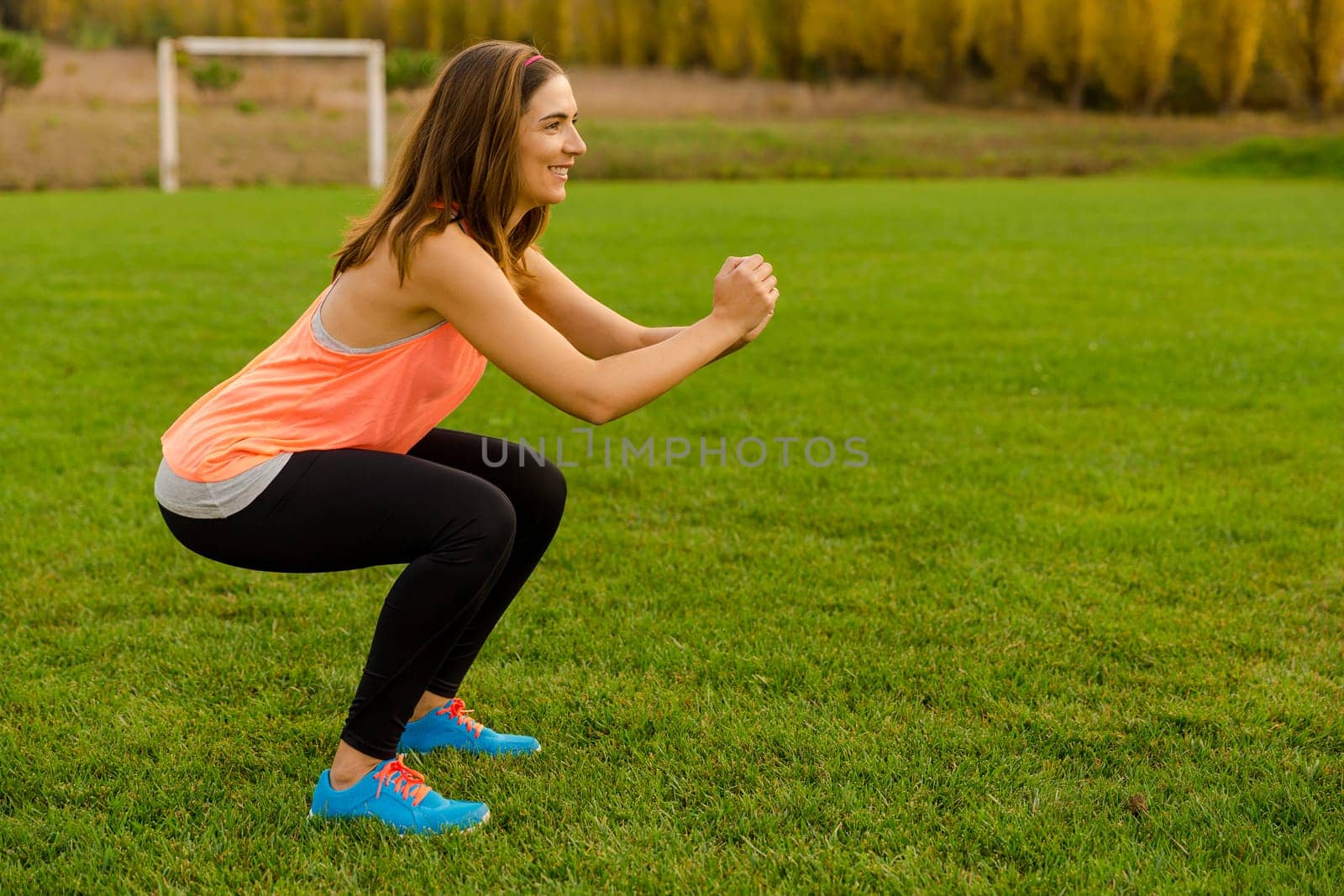 An attractive woman exercising outdoor on a soccer field