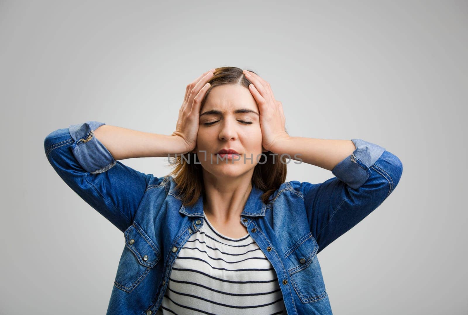 Portrait of a stressed woman holding head in hands