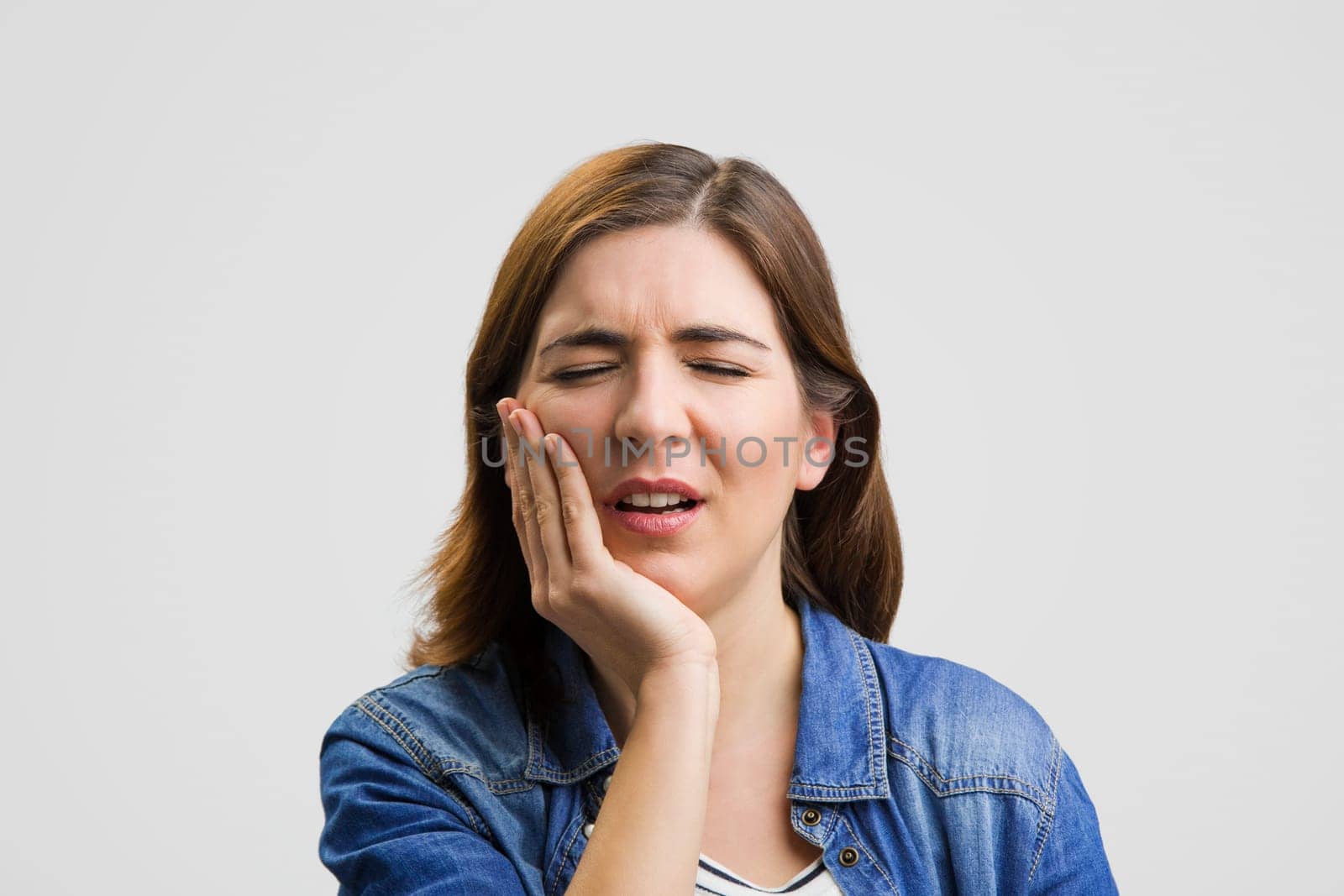 Frustrated woman in pain with a sore throat