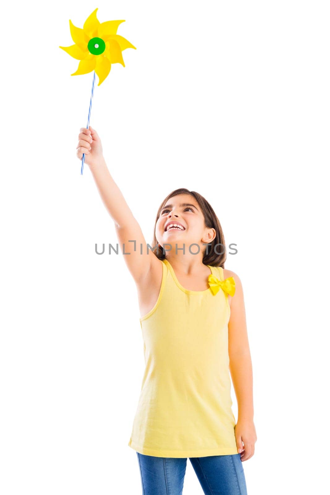Beautiful girl blowing a plastic windmill