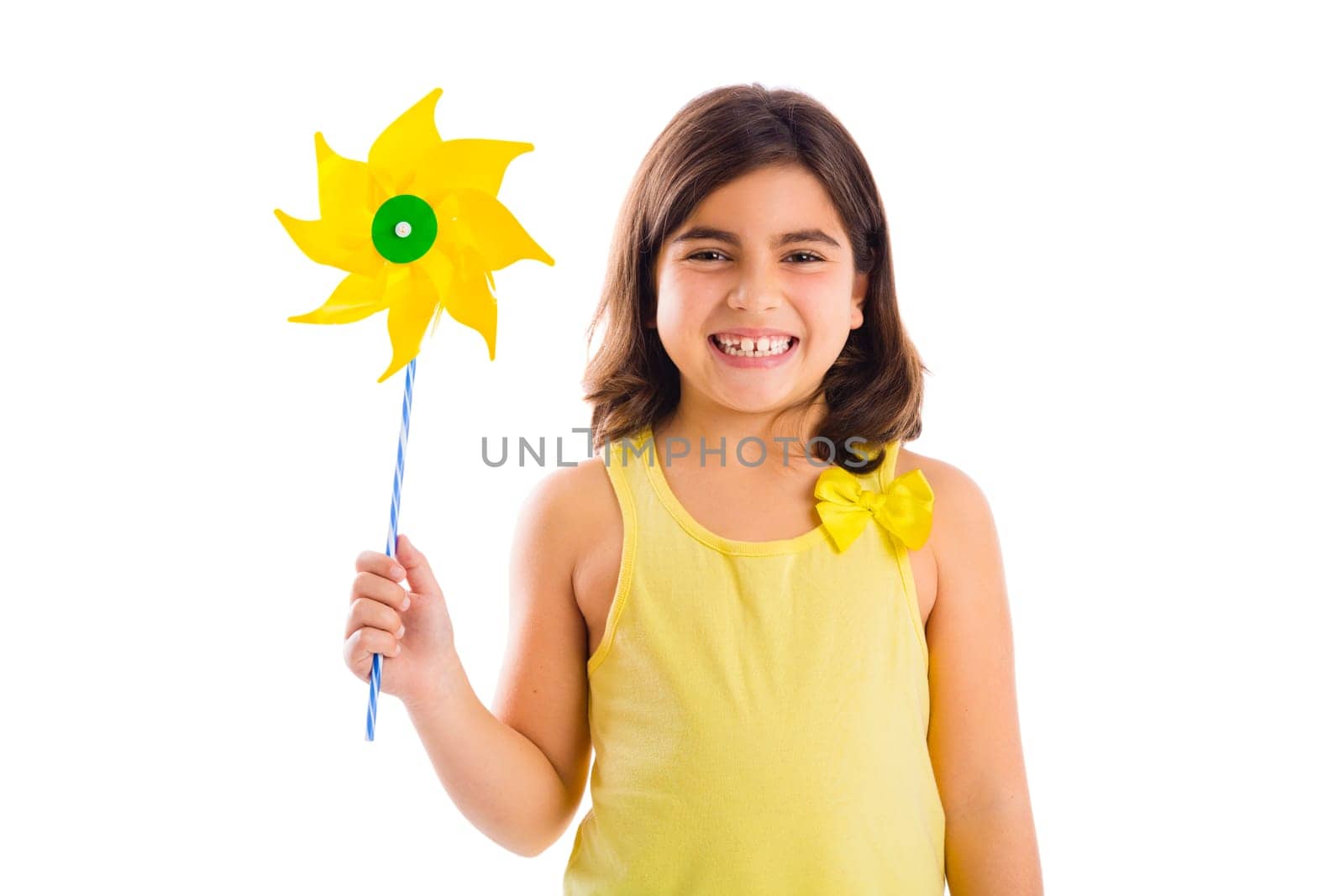 Beautiful girl blowing a plastic windmill