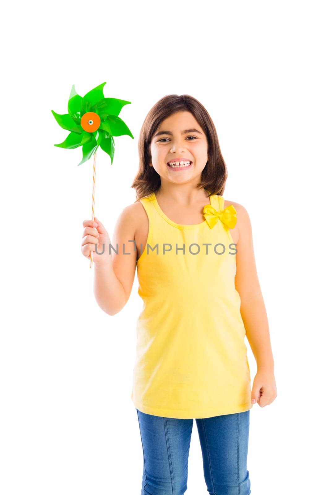 Beautiful girl blowing a plastic windmill