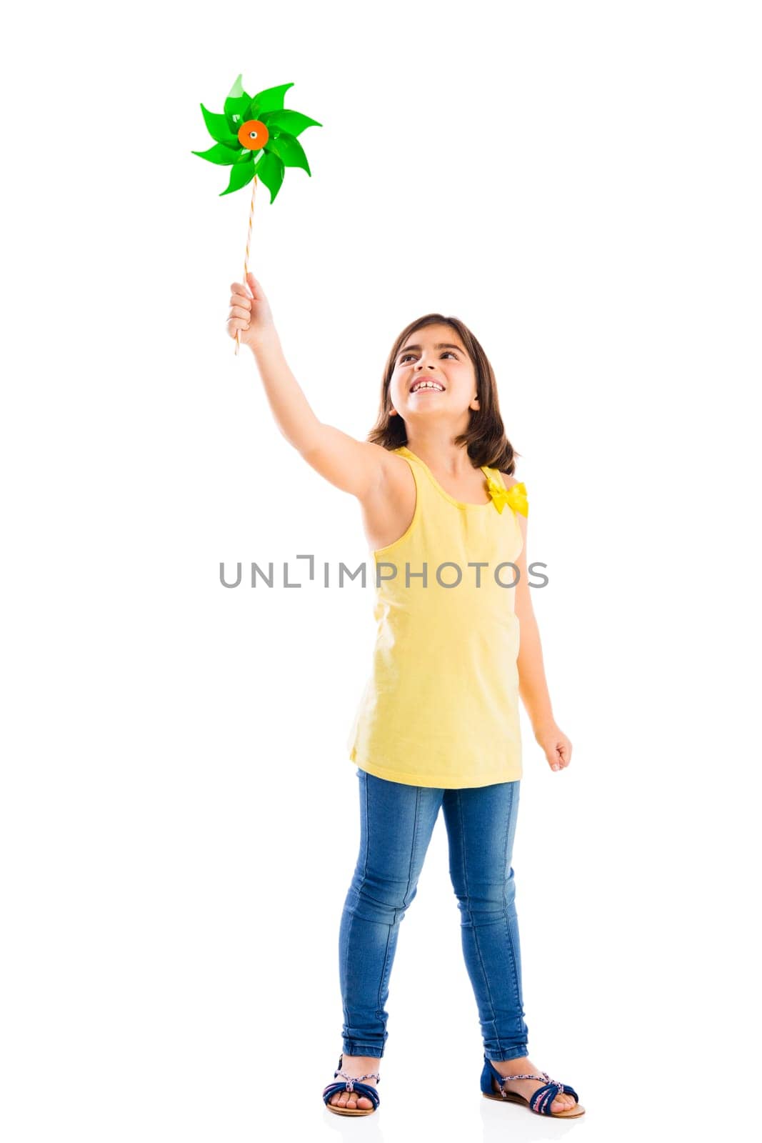 Beautiful girl blowing a plastic windmill