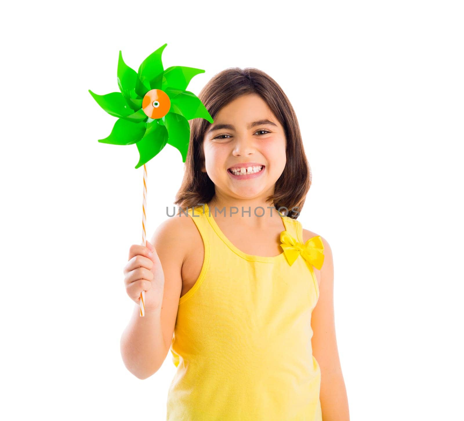 Beautiful girl blowing a plastic windmill