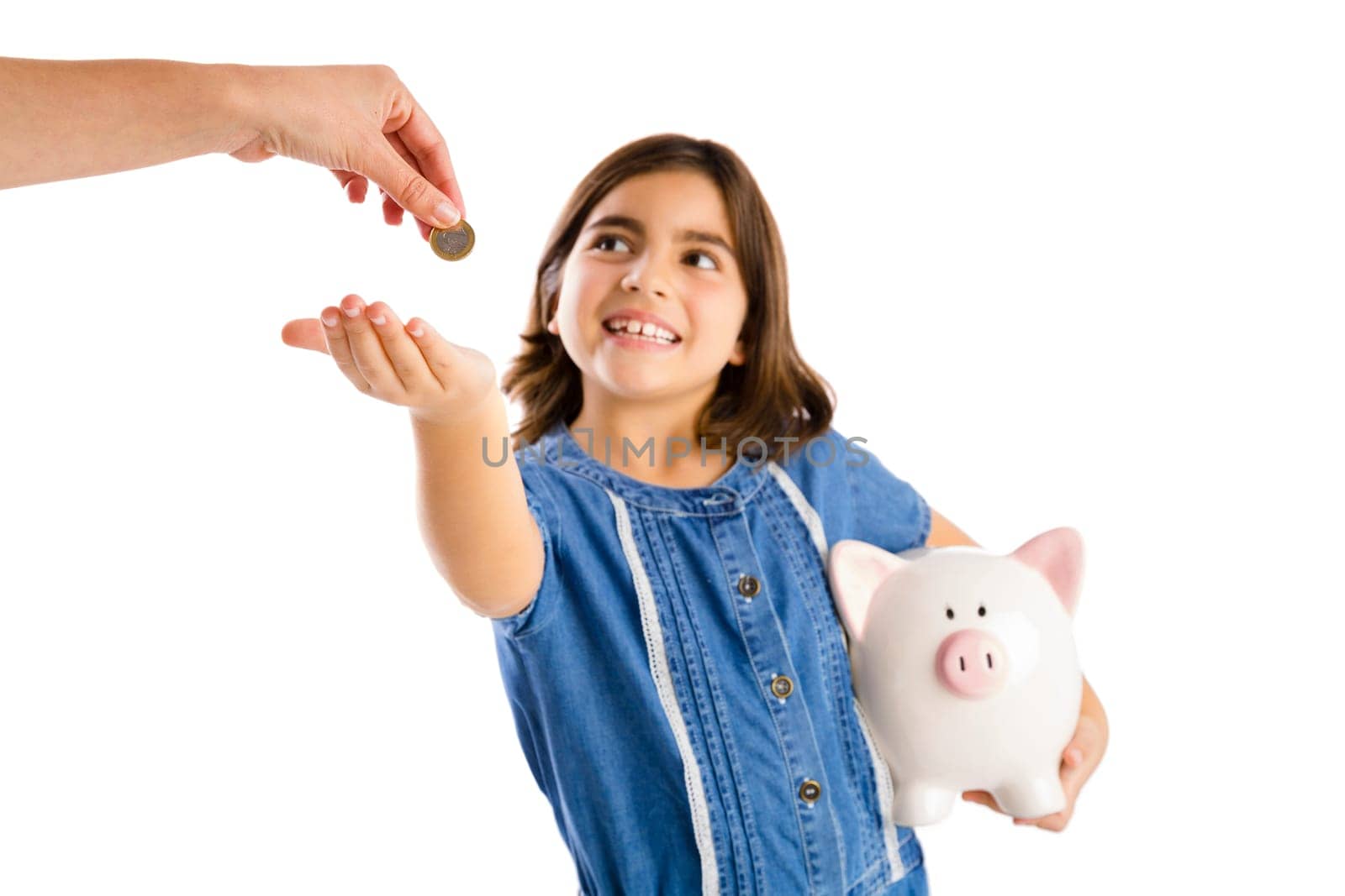 Young girl start her savings on a piggybank