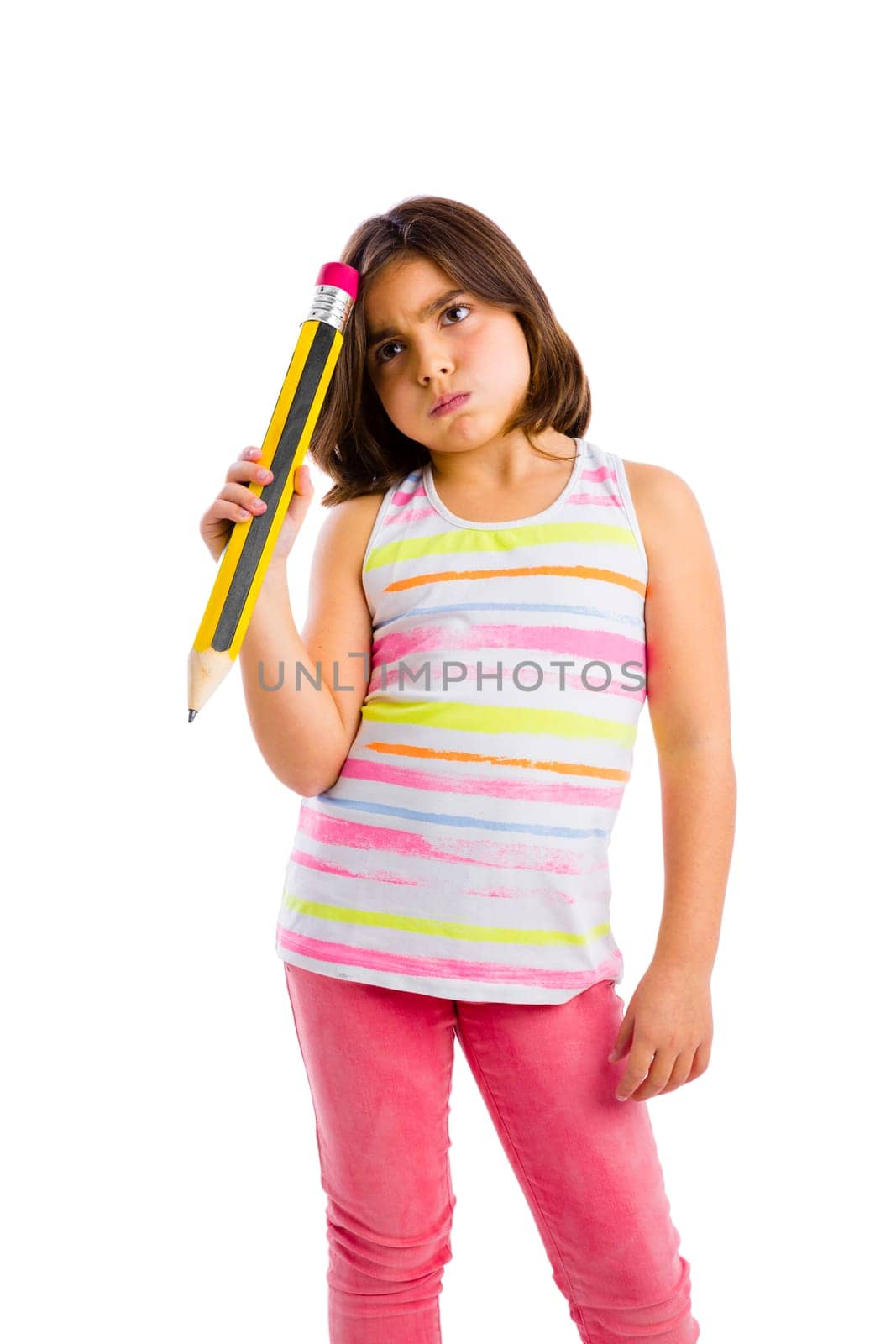 Beautiful young girl with a thinking expression while holding a big pencil