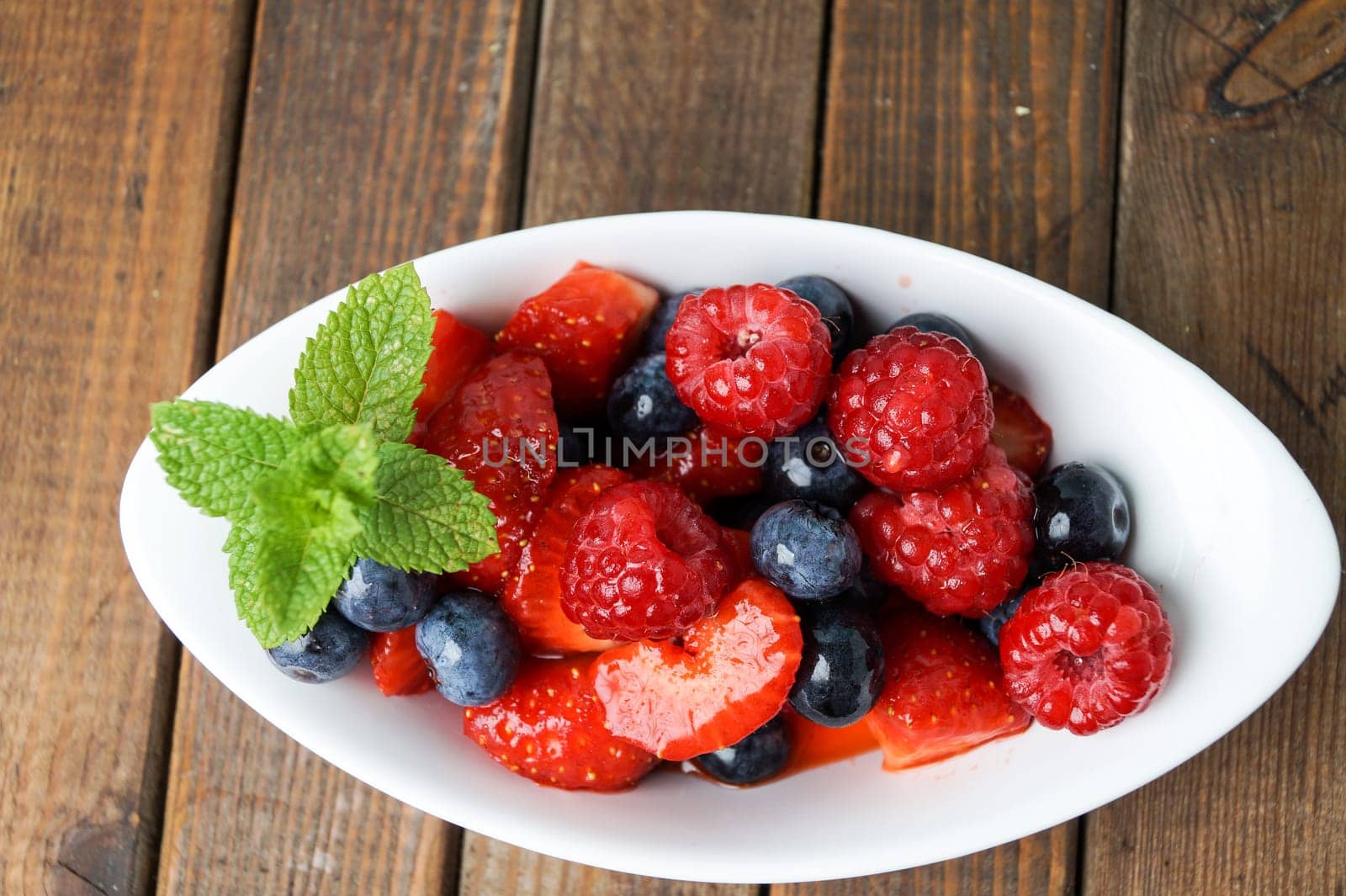 Delicious marinated fruitsalad, red juicy and ready to eat
