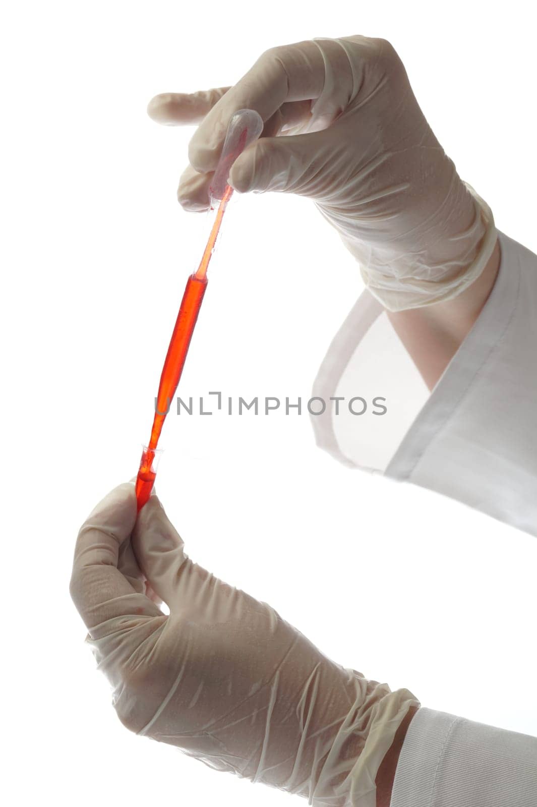Hand, pipette and testtube with sample isolated on white