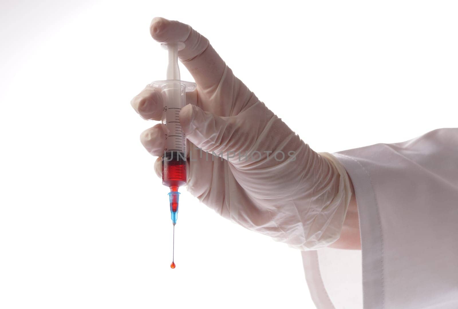 Hand with blood sample in syringe on white background