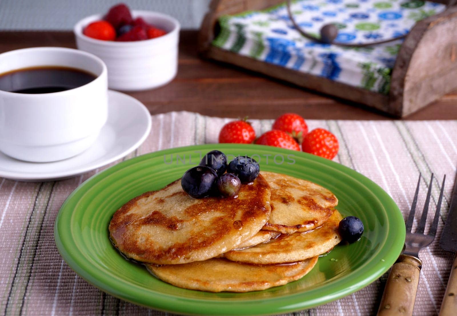 Breakfast table with pancakes, blueberry and coffee