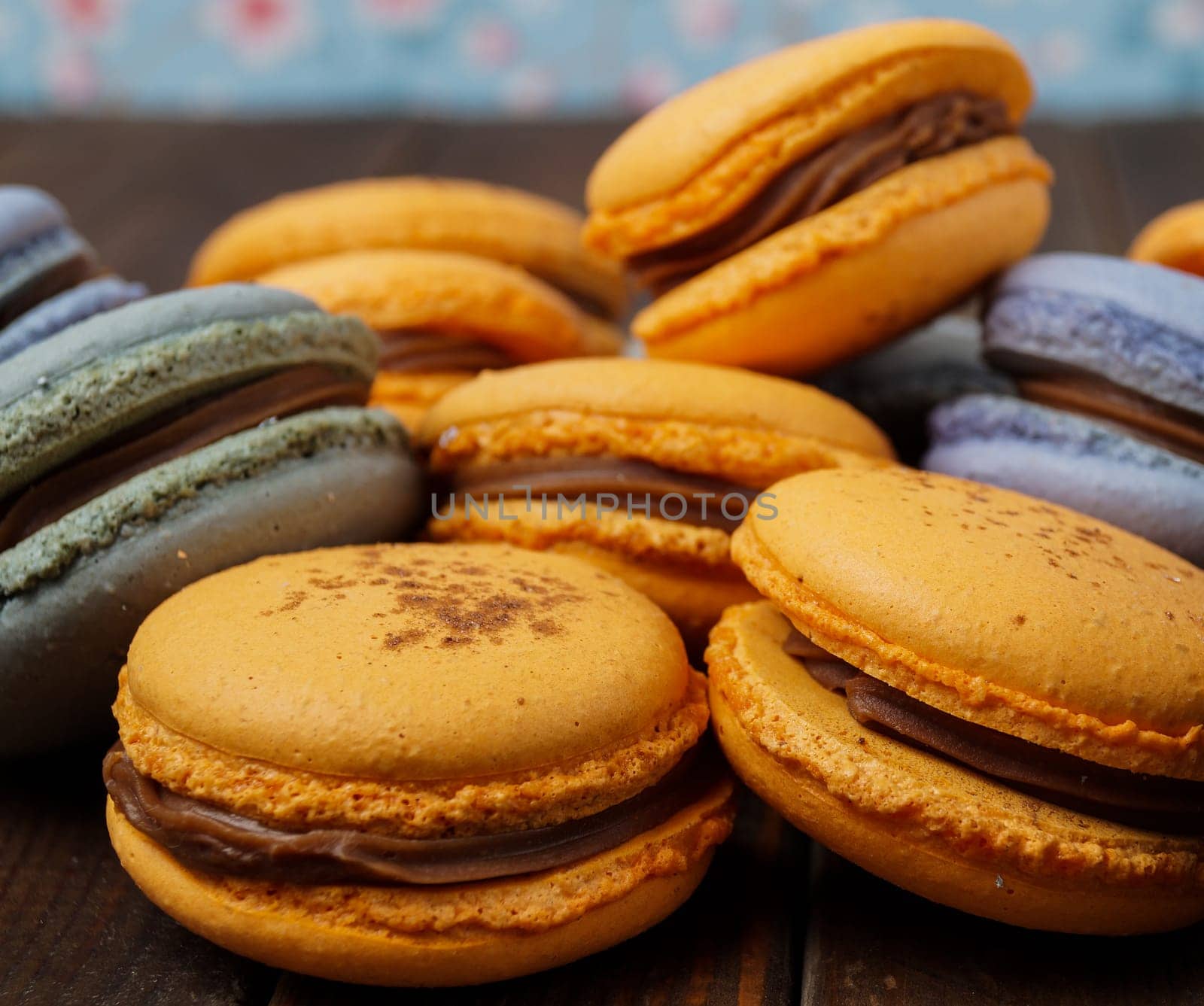 pile of delicious blue and orange macaroons with ganache filling