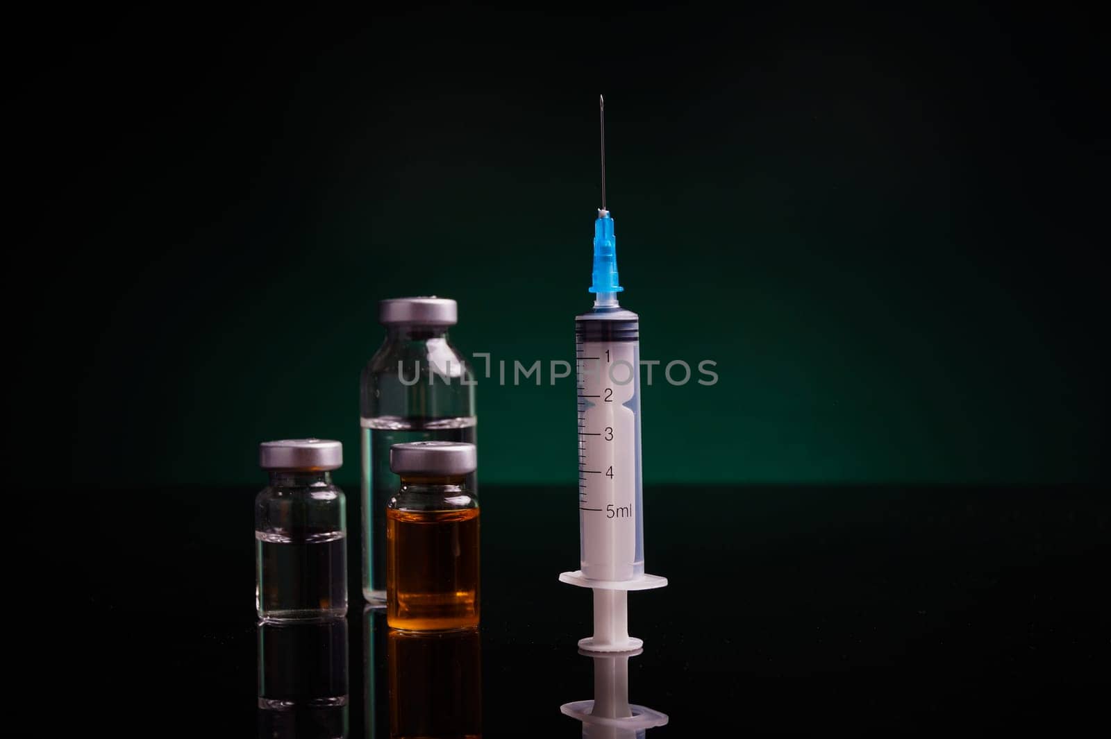 Syringe and medical vials with green backlight