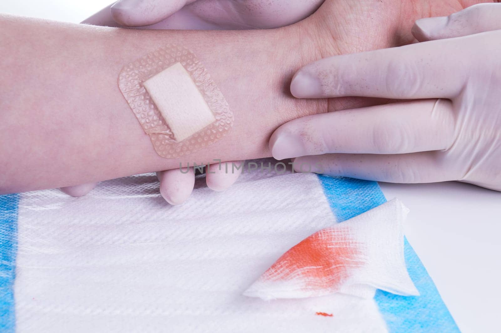 Adhesive Bandage. Bandaging at Wound by the Doctor