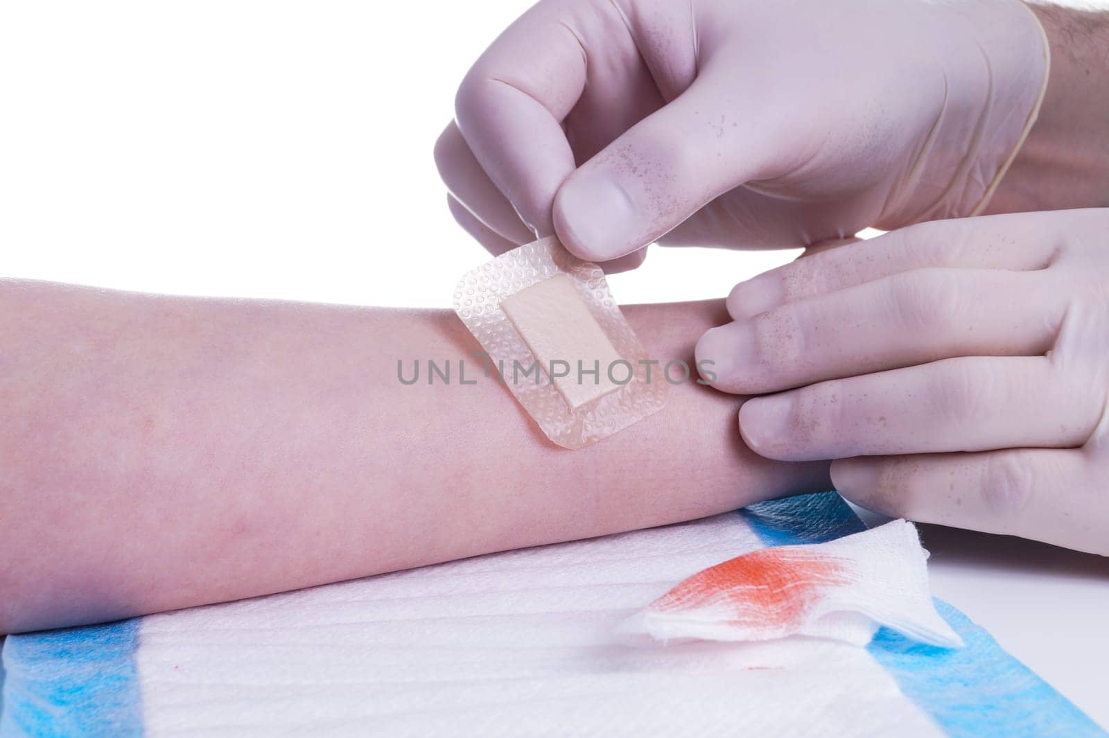 Adhesive Bandage. Bandaging at Wound by the Doctor