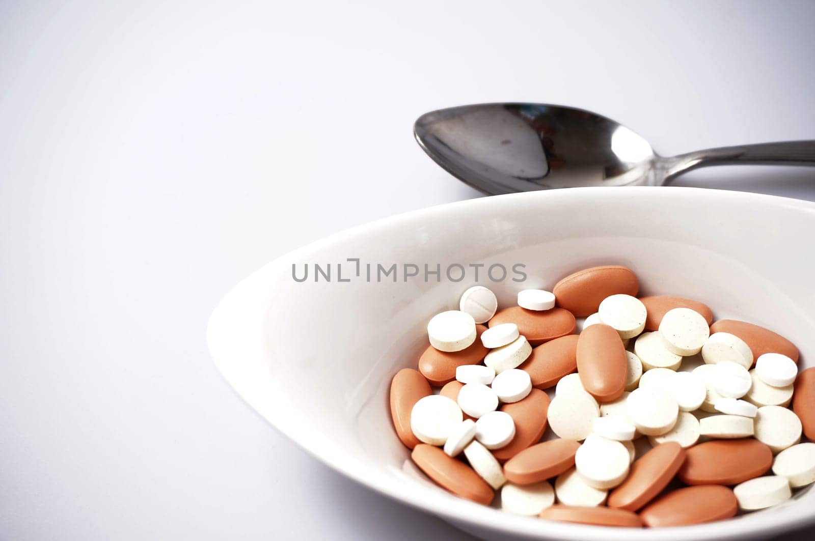 prescription drugs in a bowl whit a spoon