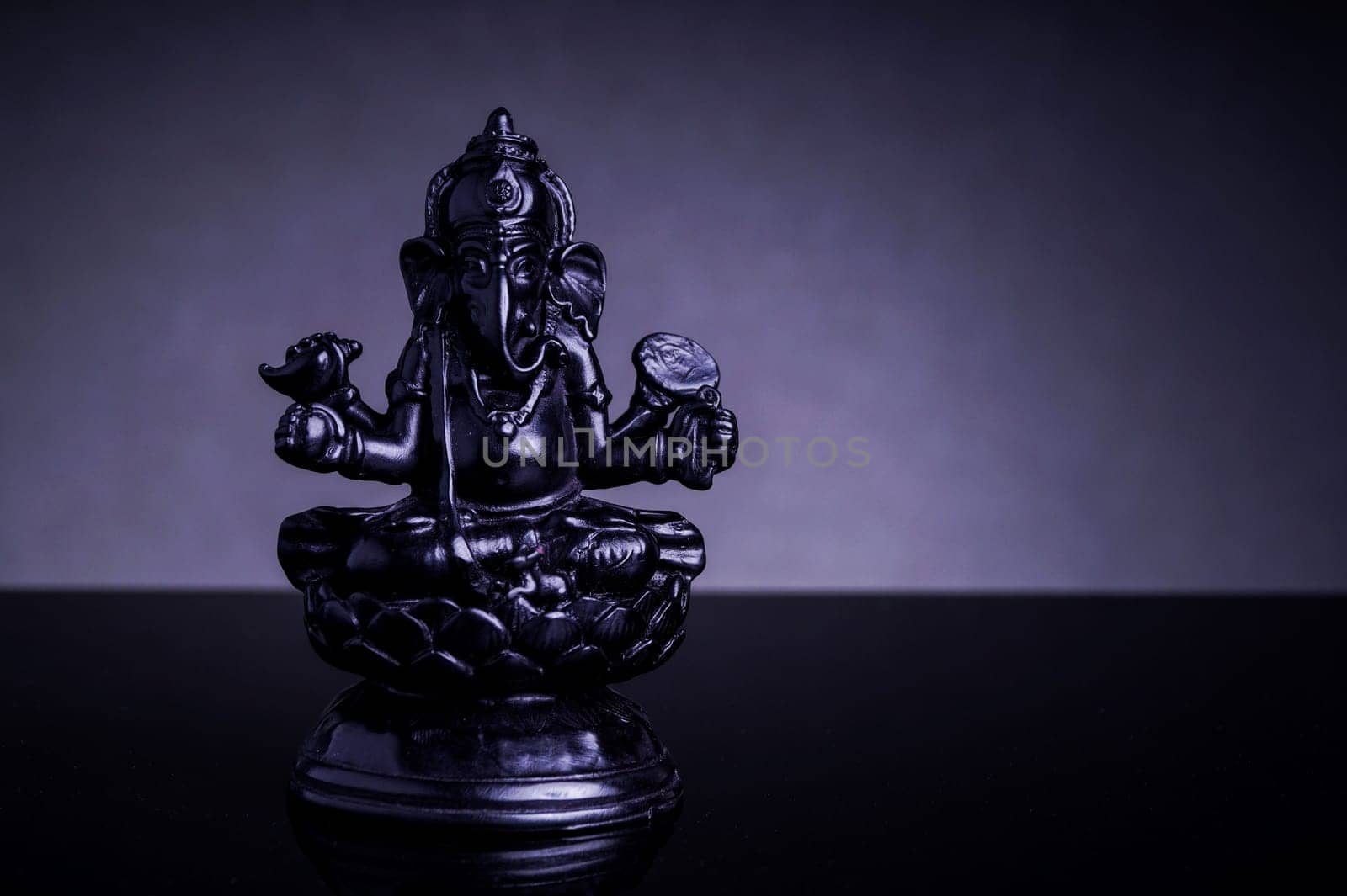 Statue of the Hindu God Ganesha with grey background