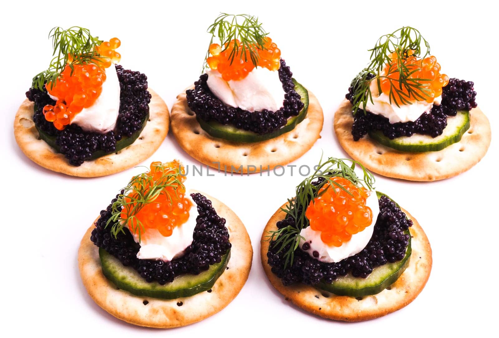 Caviar Appetizer served on crackers isolated on white