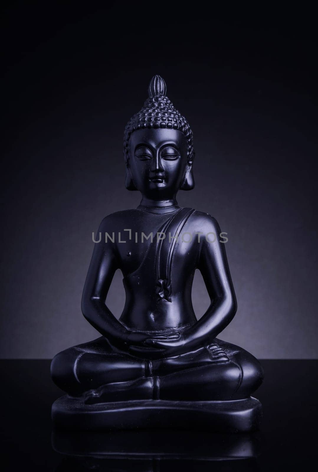 Statue of the Buddah with grey backlight