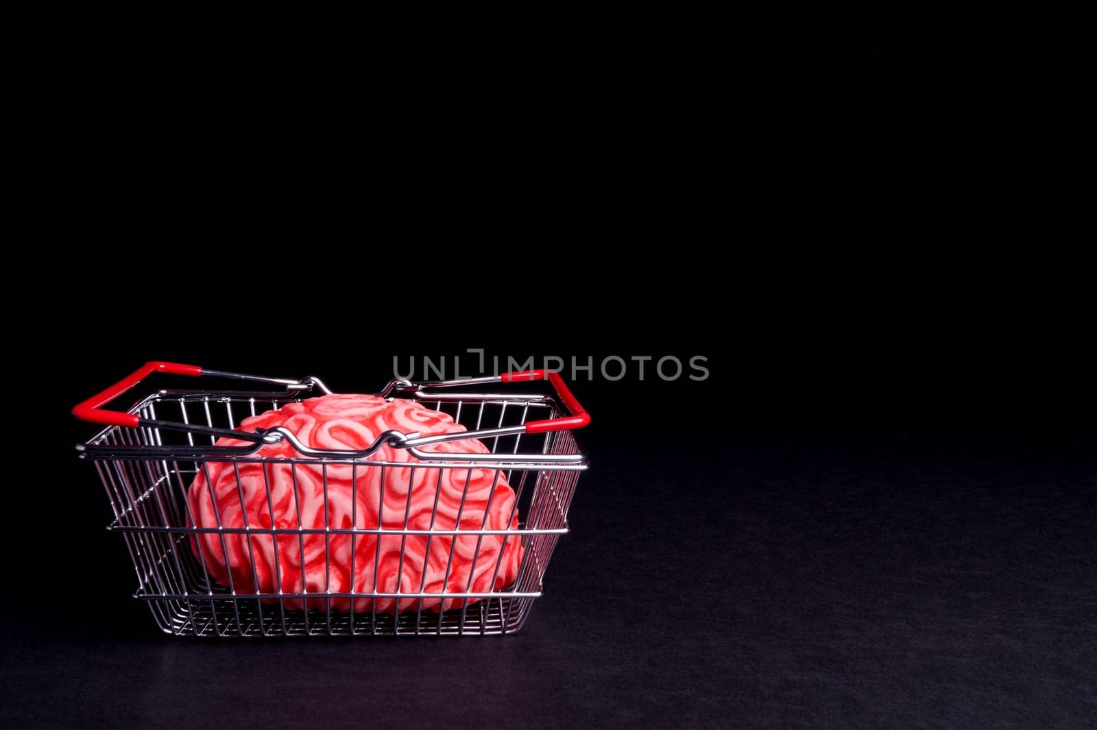 Think before you Bye. Brain and shoppingcart isolated on Black