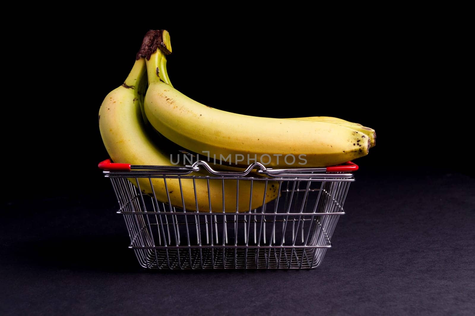 Basket of Ripe Organic Bananas isolated on Black