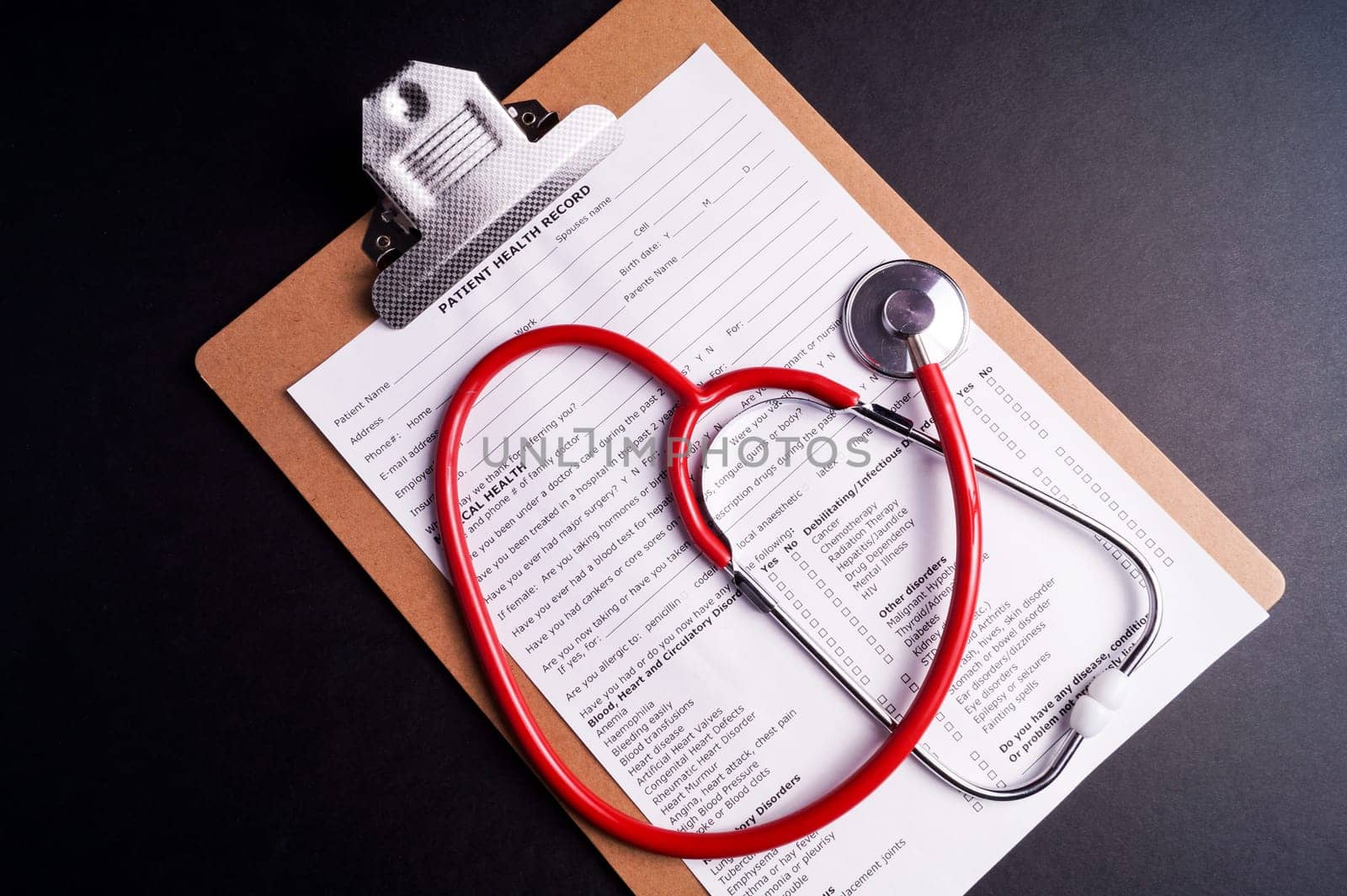 Medical Chart and stethoscope isolated on black background