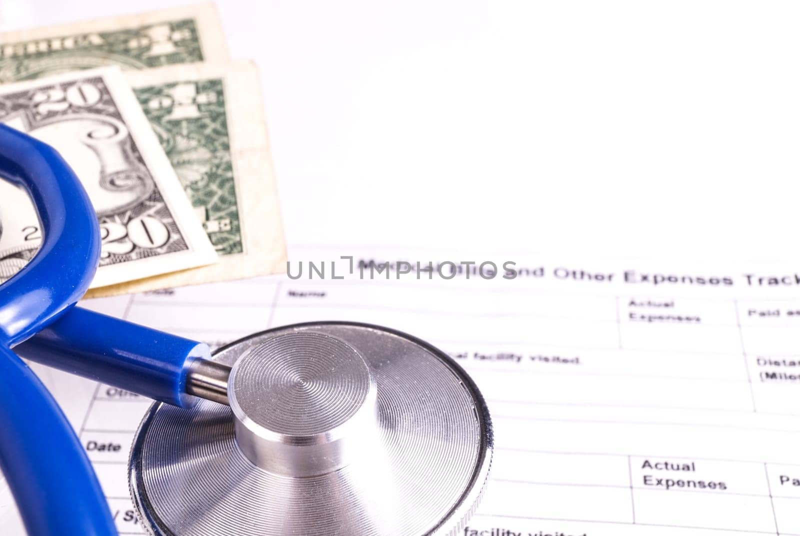 Medical Bill Statement with Stethoscope and Money, All text is anonymous. The Stephoscope is Blue. Hospital Bill