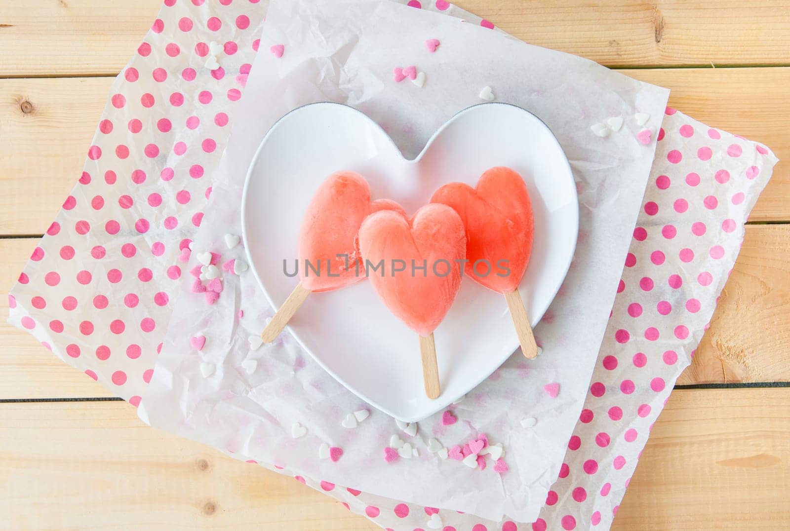 Ice cream on the stem in heart shape on heart plate