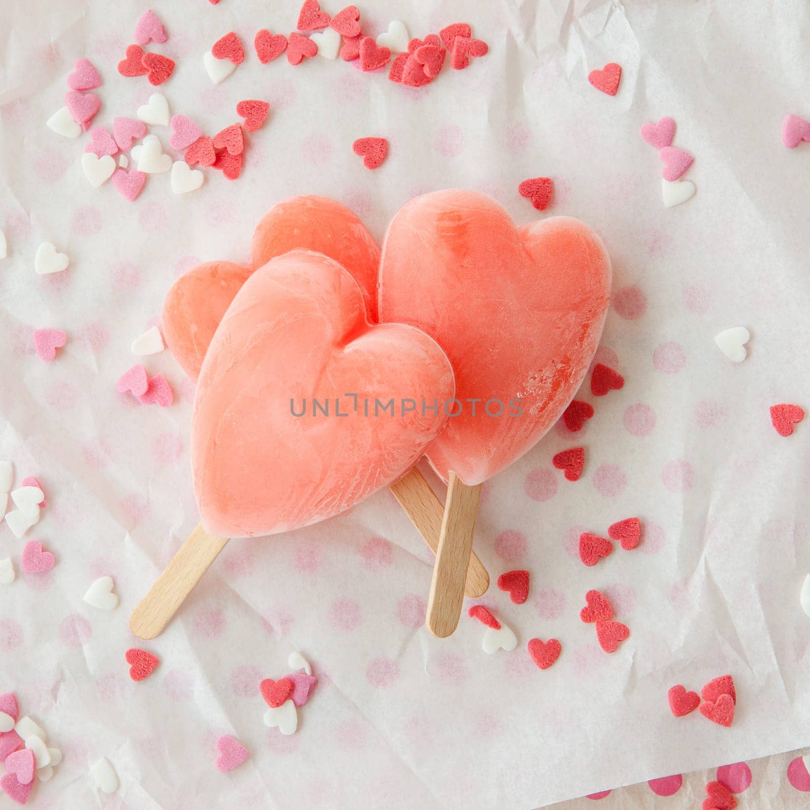 Ice cream on the stem in heart shape with colorful sugar hearts