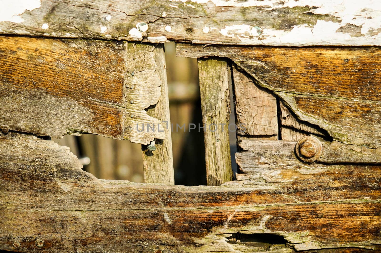 There are knocked a hole in the side of an old wooden boat