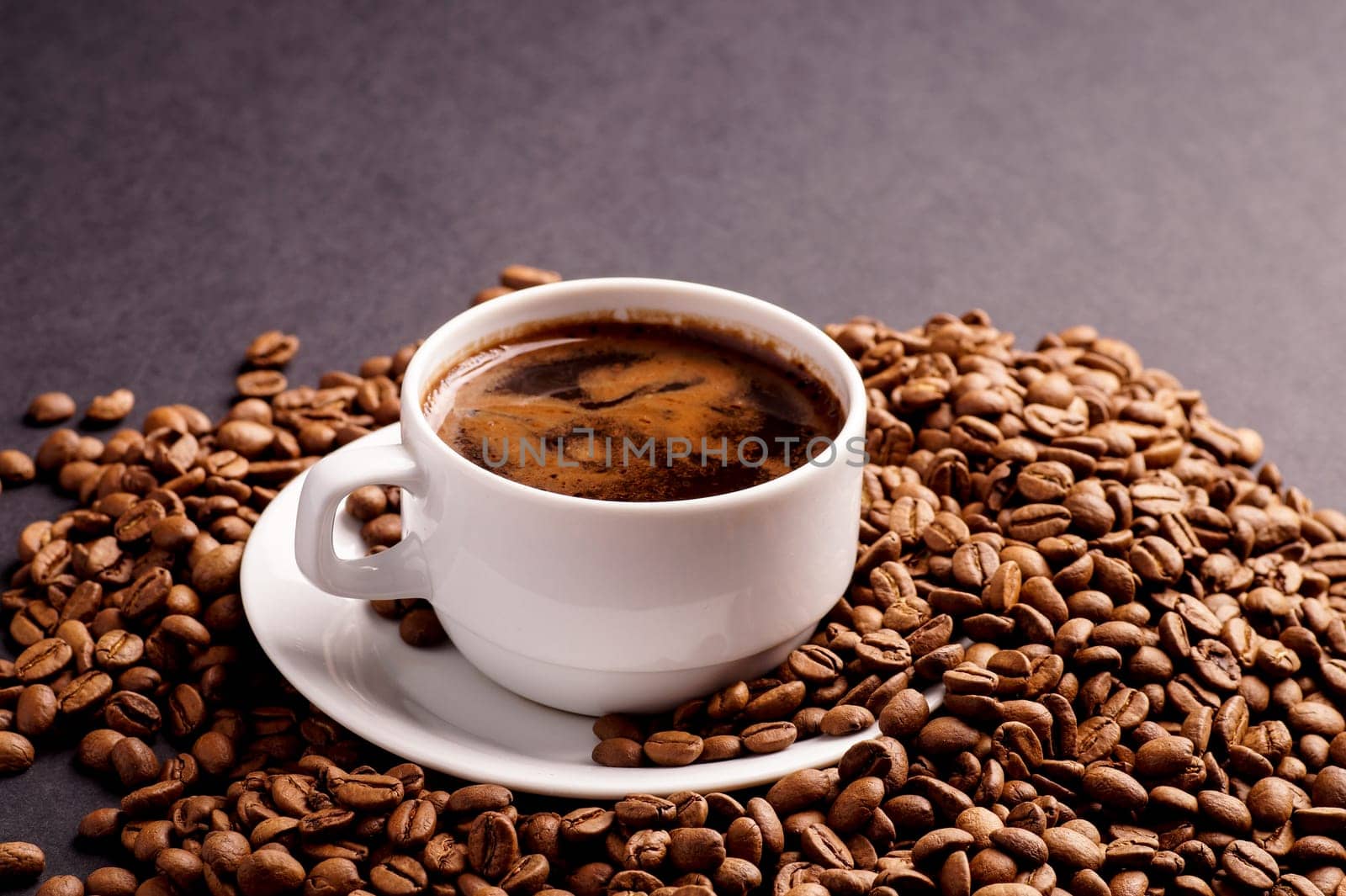 Coffee in a cup and a pile of Coffee Beans