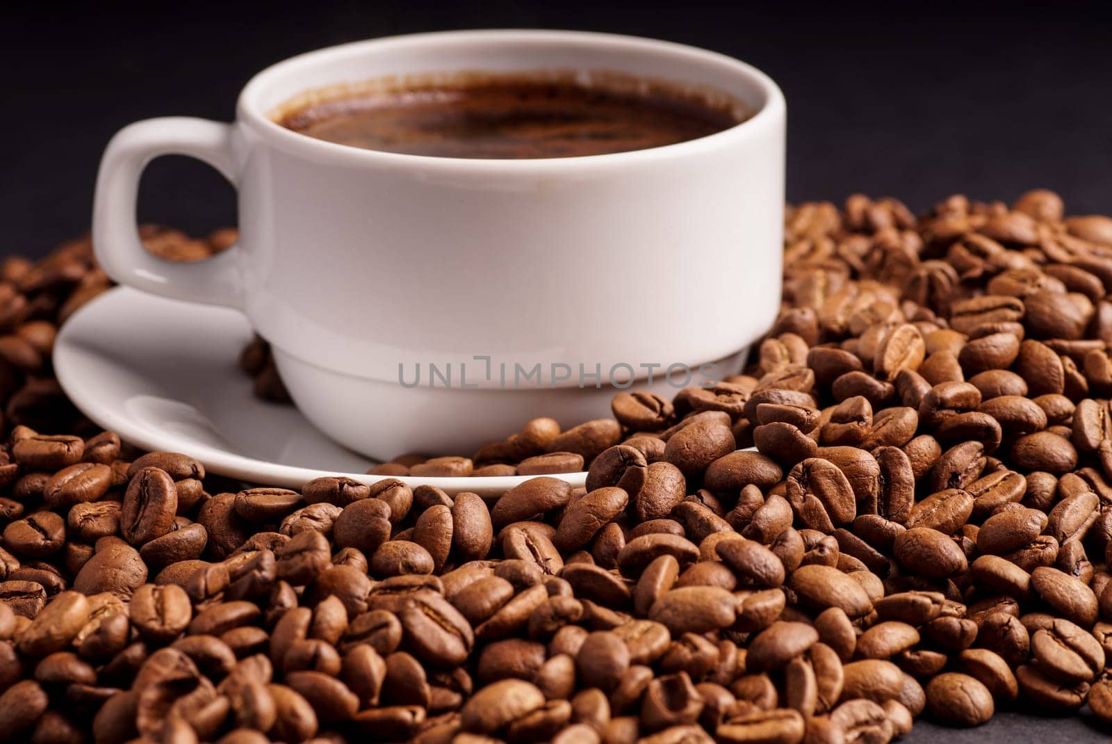 Coffee in a cup and a pile of CoffeeBeans
