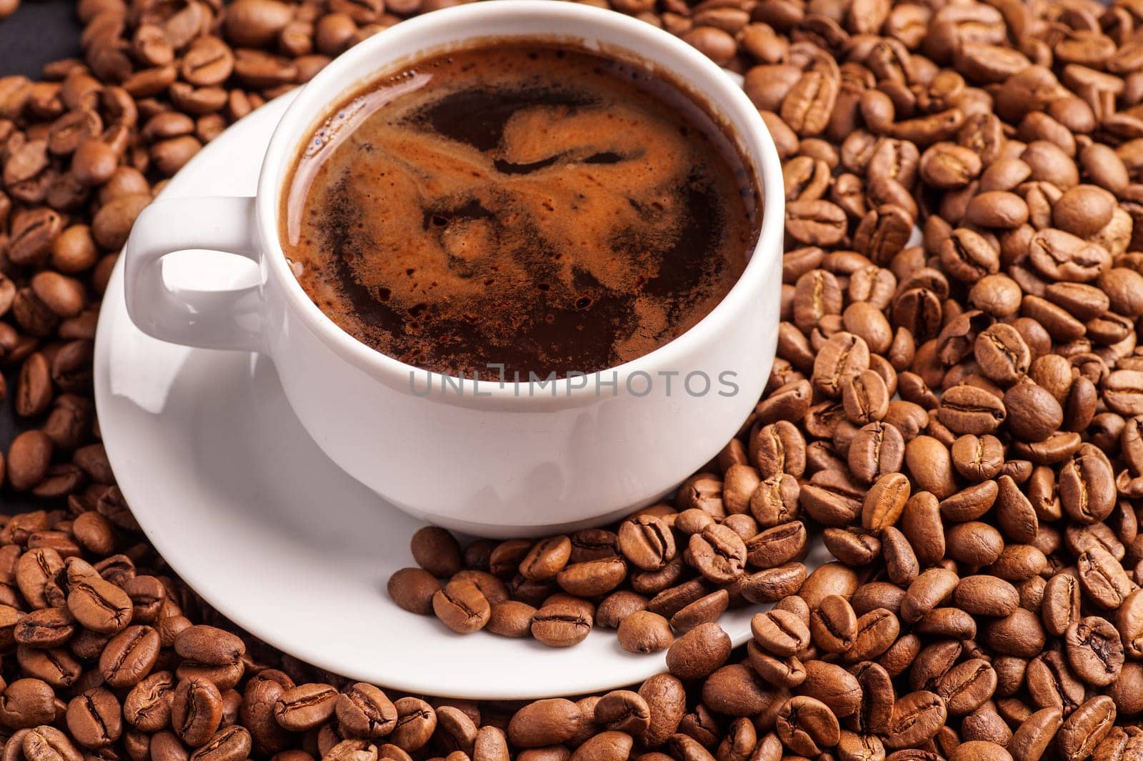 Coffee in a cup and a pile of CoffeeBeans
