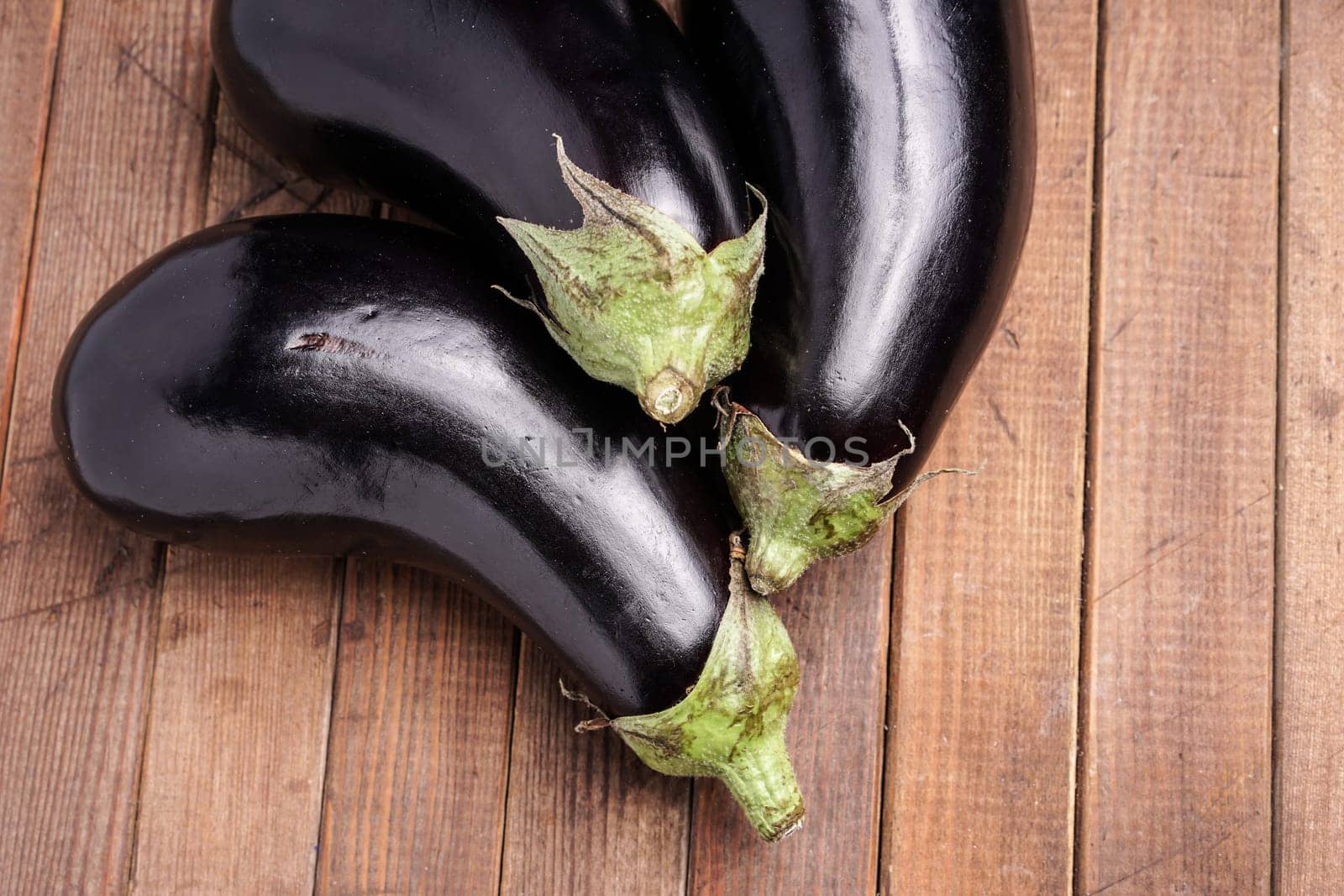 Healthy Organic Eggplant, lying on a wooden board