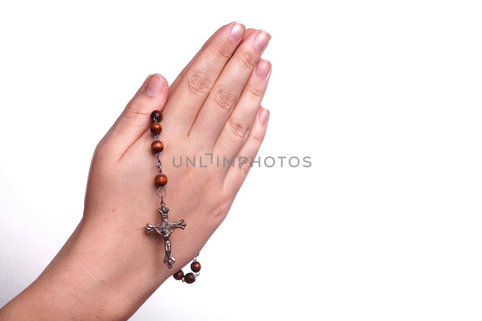 Hands of a woman Praying with Rosary, isoalted on white