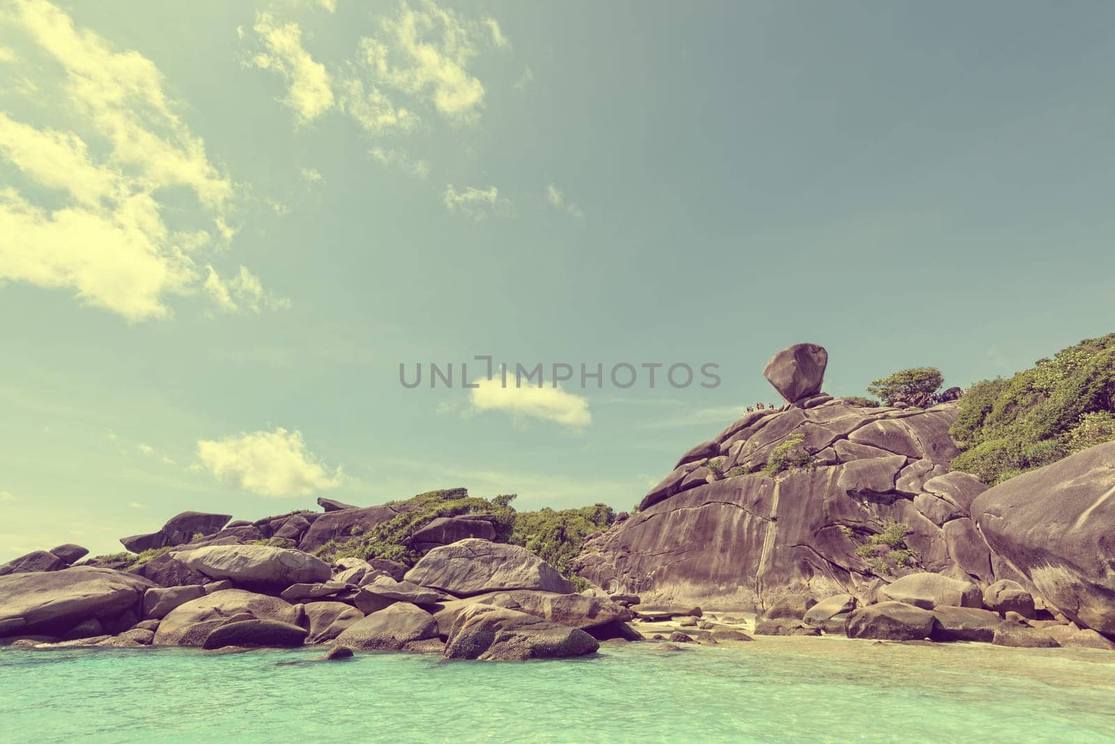 Vintage style beautiful landscape people on rock is a symbol of Similan Islands, blue sky and cloud over the sea during summer at Mu Ko Similan National Park, Phang Nga province, Thailand
