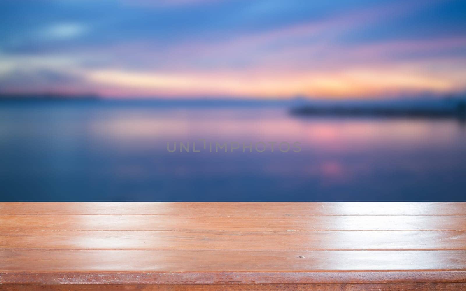 Old empty wooden table top with sunset background